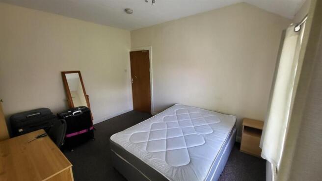 Bright, simply furnished double bedroom with a ...