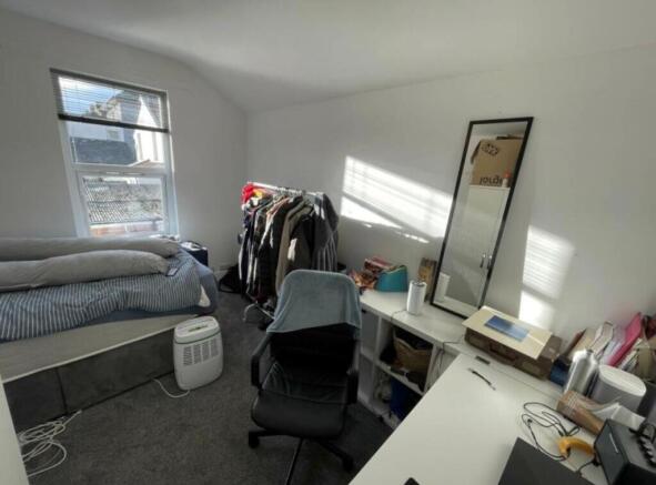 Bright, recently-decorated bedroom with a large...