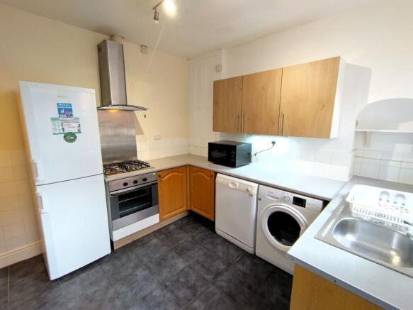Modern kitchen with full appliances and storage...