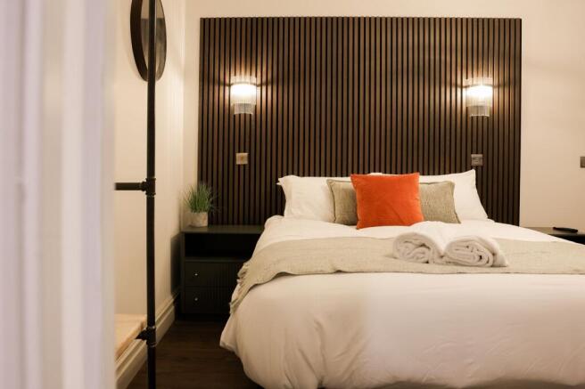Stylish bed with modern wood panel headboard...