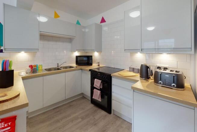Modern fitted kitchen with white gloss cabinets...
