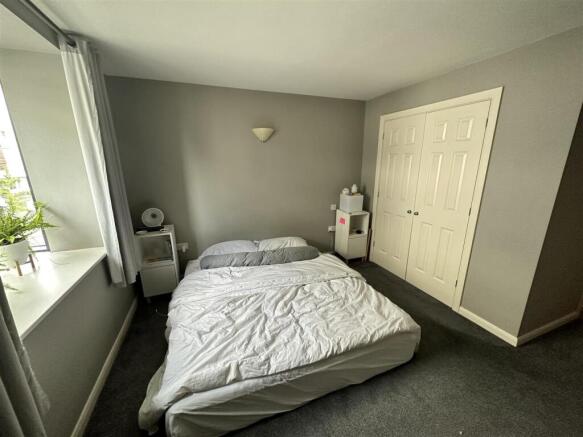 Bright double bedroom with ample built-in stora...