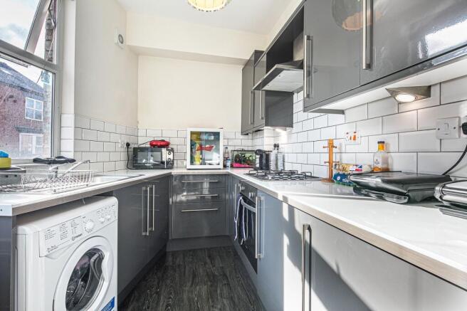 Modern gloss kitchen with sleek integrated unit...