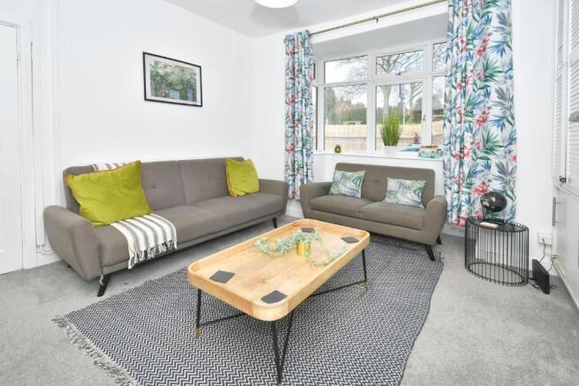 Bright, modern living room with two comfortable...