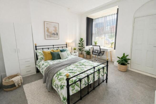 Bright, stylish double bedroom with a black met...