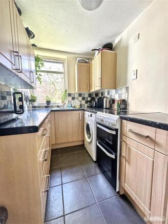 Bright kitchen with modern integrated appliance...