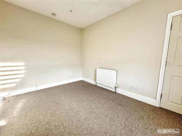 Bright and spacious neutral bedroom with carpet...