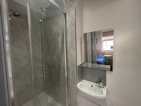 Modern ensuite with glass shower and vanity...