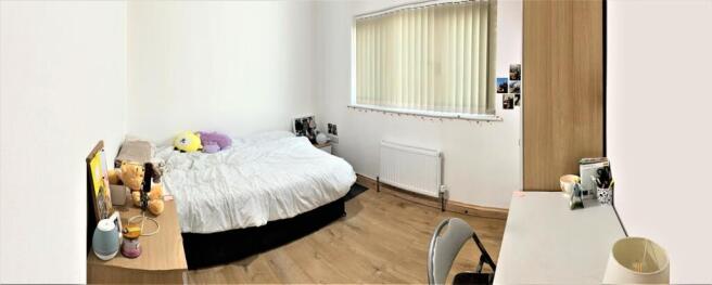 Spacious and bright double bedroom featuring a ...