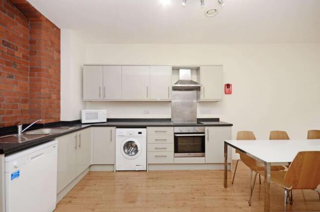 Bright modern kitchen with light cabinetry, int...