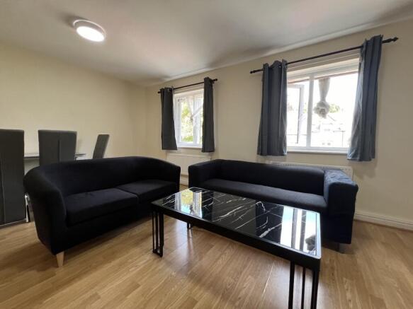 Bright, modern living room with two comfortable...