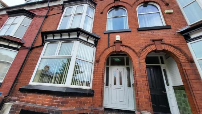 Traditional red-brick terraced house frontage w...