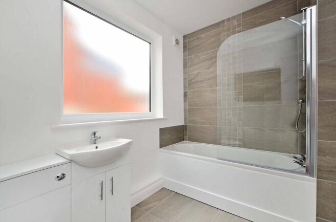 Modern, well-maintained bathroom featuring a ba...