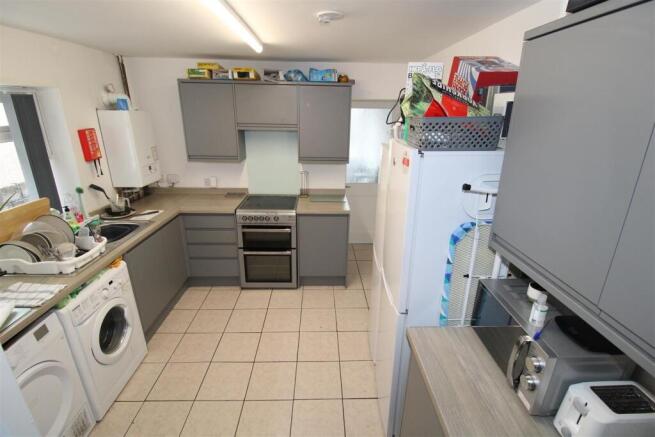 Modern grey kitchen with ample storage and spac...