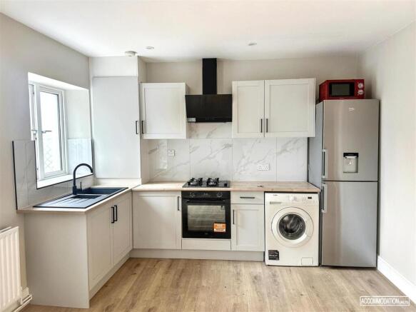 Bright modern kitchen with integrated appliance...