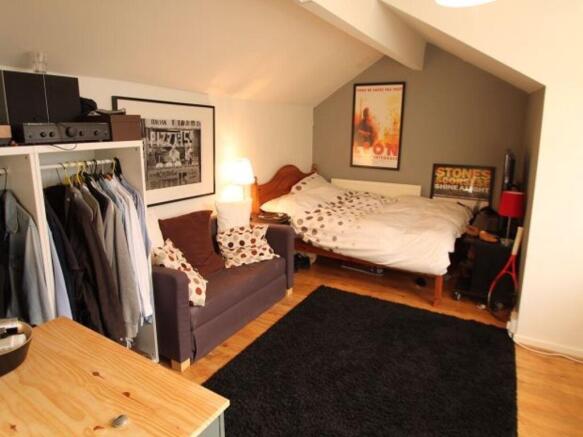 A spacious and well-lit master bedroom featurin...
