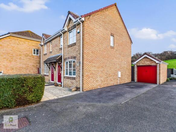 View Of Property With Drive And Garage