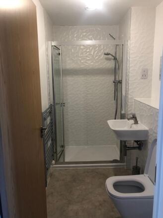 Modern bathroom with a walk-in shower and textu...