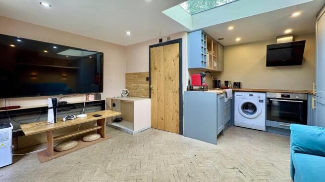 Bright lounge with skylight and huge smart TV...