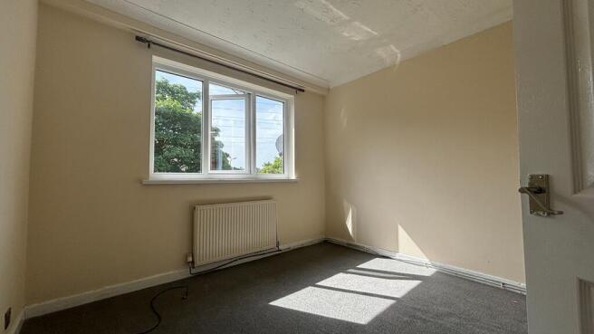 Bright and airy bedroom with large window...