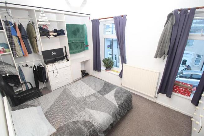 Bright bedroom with ample storage and large win...