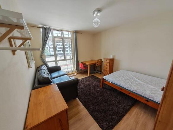 Bright master bedroom with sofa and study desk...