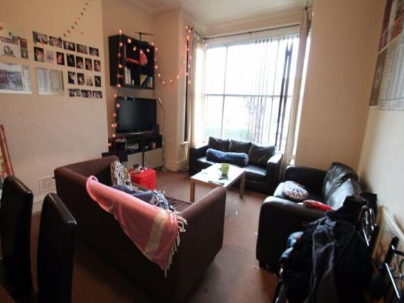 A cozy living room with a large window allowing...