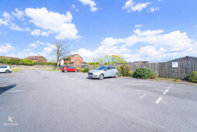 Suburban parking lot on a sunny day.png