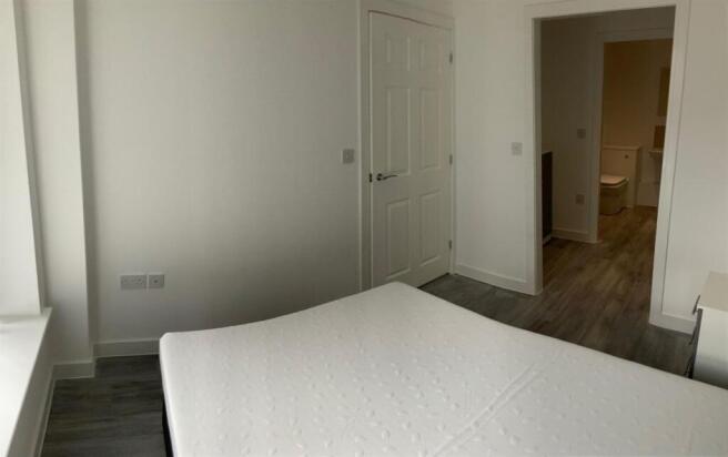 Bright, neutral double bedroom with modern floo...