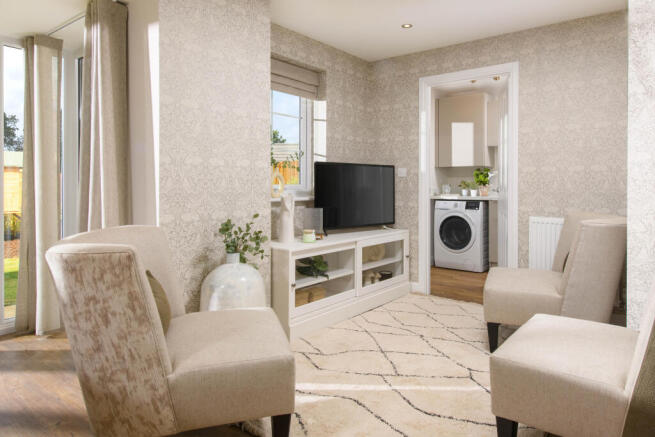 Open-plan kitchen with integrated appliances, dining area & family room with French doors leading on