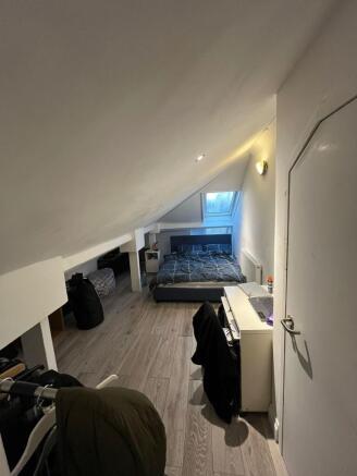 Cozy loft double bedroom with low sloped ceilin...