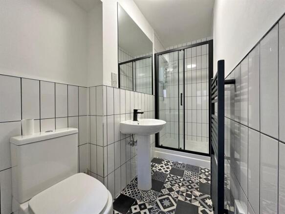 Modern bathroom with stylish patterned flooring...