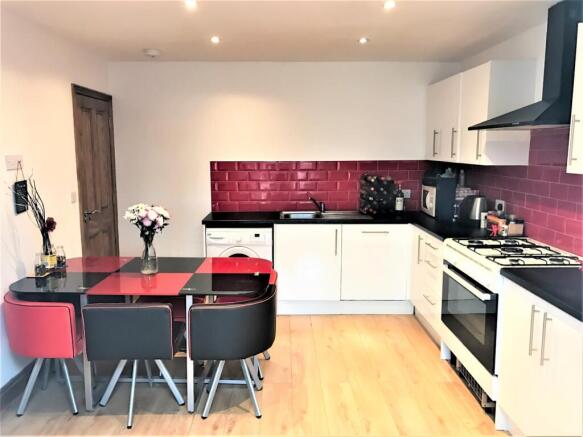 Modern kitchen featuring sleek cabinetry, a vib...