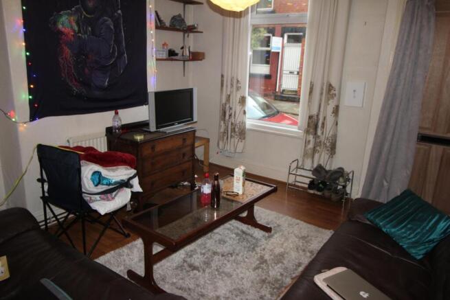 Cosy furnished living room with wood floors, a ...