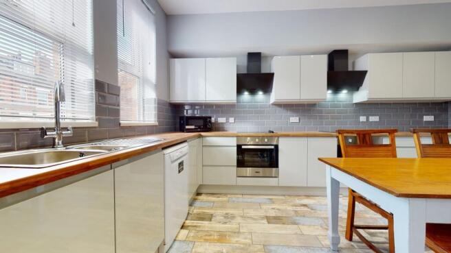 Modern kitchen with ample natural light from la...