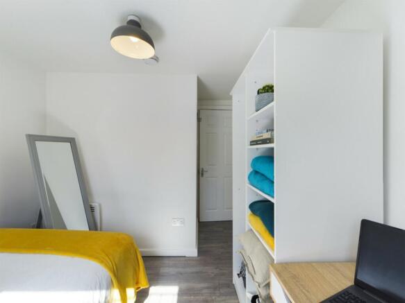 A bright and tidy double bedroom featuring styl...