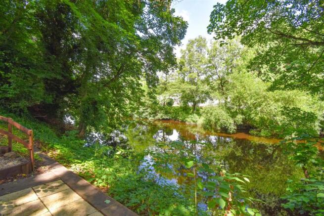 Landscaped Riverbank + Riverside Patio