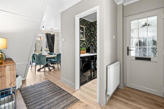 Hallway With View Of Utility & Dining Area