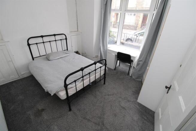 Bright bedroom with double bed and desk area...