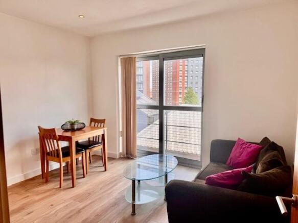 Bright living area with large floor-to-ceiling ...