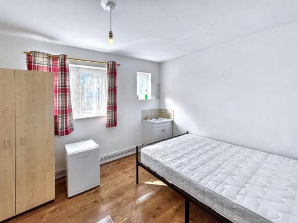 Bright double bedroom with useful in-room sink...