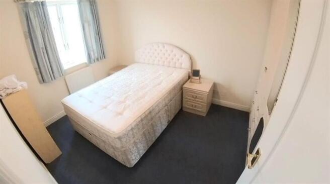 Bright, simply furnished double bedroom with a ...