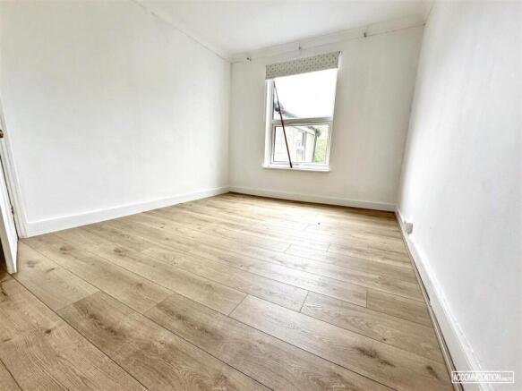 Bright bedroom with stylish wooden flooring...