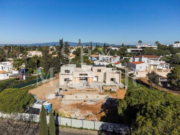 Aerial construction view of a luxury contemporary villa on an elevated plot in Salicos Carvoeiro Algarve
