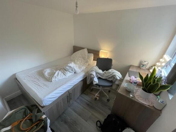 A bright and welcoming bedroom with a comfortab...