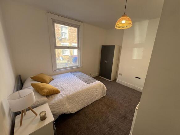 A bright and welcoming double bedroom featuring...