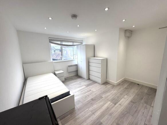 Bright, modern bedroom with storage and large b...