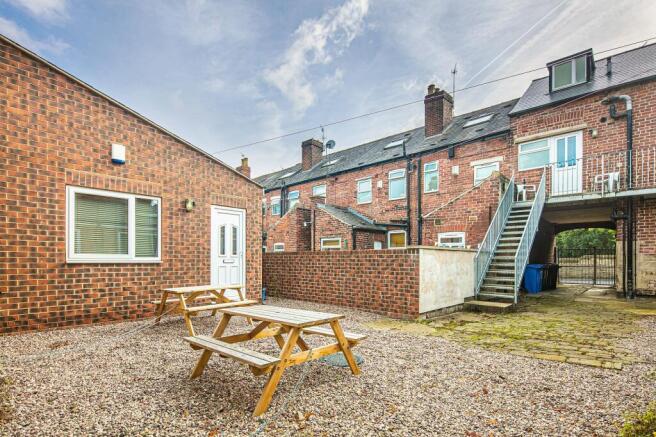 Private paved courtyard with picnic benches and...