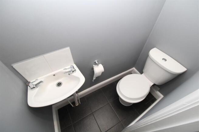 Modern and clean cloakroom with sleek tiling...