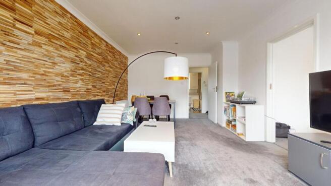 Bright, modern living room with a large dark se...